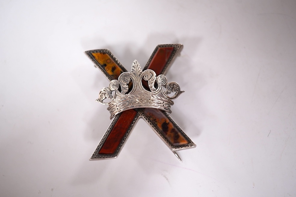 A late Victorian white metal and Scottish hardstone set 'X' brooch with coronet, 34mm, together with a silver hinged bangle and a George V silver mounted handbag mirror, with Reynold's Angels decoration. Condition - poor